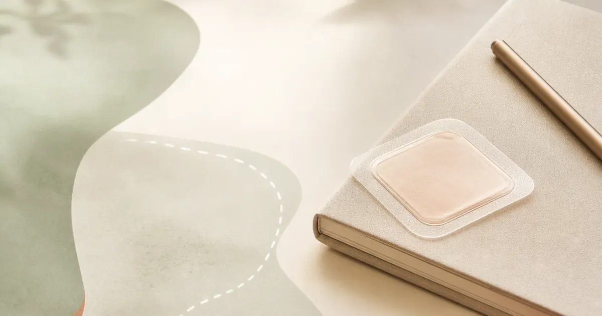 Editorial illustration of a menopause visit notebook beside an estrogen patch, representing HRT route choices